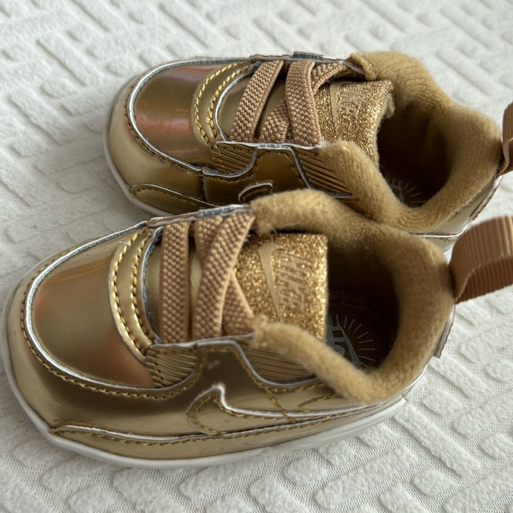 Nike baby shoes in gold
